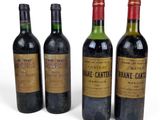 trois bouteilles de vin posées les unes à côté des autres sur une surface blanche