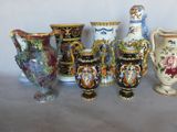 many vases that are lined up on a table