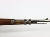an old rifle with a wooden barrel and a metal handle