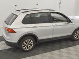 the back end of a white volkswagen suv parked in a garage