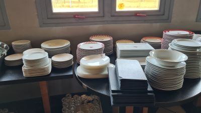 a lot of plates on a table with a window in the background