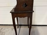 an old wooden chair sitting on top of a hard wood floor