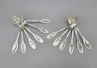 pair of silver plated spoons with leaves on them