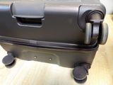 a black piece of luggage sitting on a wooden table