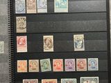 many different stamps on a book with a black cover