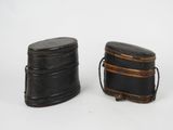 pair of black leather boxes on a white background
