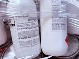 several cans of paint are wrapped in plastic and sitting on a table