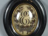 a picture of a picture of a monogram in a black frame