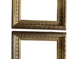 a pair of gold picture frames on a white background