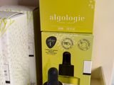 an image of a bottle of liquid sitting next to a box