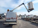 a white truck with a crane attached to it ' s back