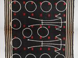 a black and red rug with circles and dots on it