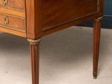 a wooden desk with a marble top on a carpeted floor