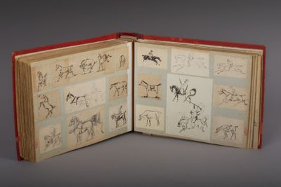 an open book with drawings of horses and people on it
