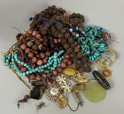 a pile of assorted beads and jewelry on a table