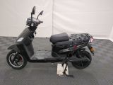 a scooter that is parked on a checkered floor