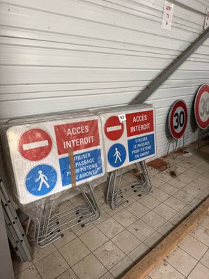 many signs on the ground near a building