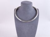 grey display case with a silver ring on top of it