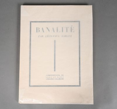 an old book with a white cover on a gray surface