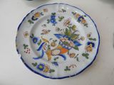 a plate with a bird on it sitting on a table