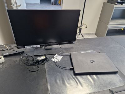 a laptop and a laptop computer sitting on a table