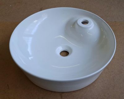 a white sink sitting on top of a brown table