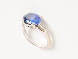 a close up of a ring with a blue stone on it