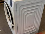 a washing machine sitting on a pallet in a room