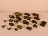 a lot of toy army vehicles on a white surface