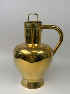 brass plated pitcher with handle on a white background