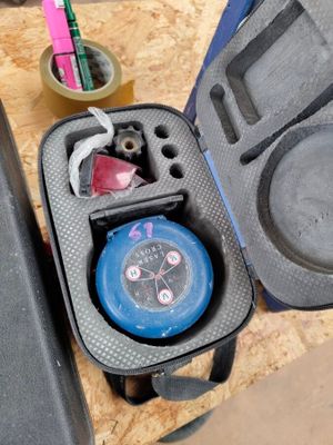 a case with a watch inside of it on a table