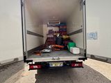 a truck that is loaded with items in the back of it