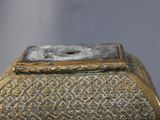 a silver and gold box with a clock on it