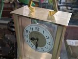 a clock that is sitting on top of a glass table