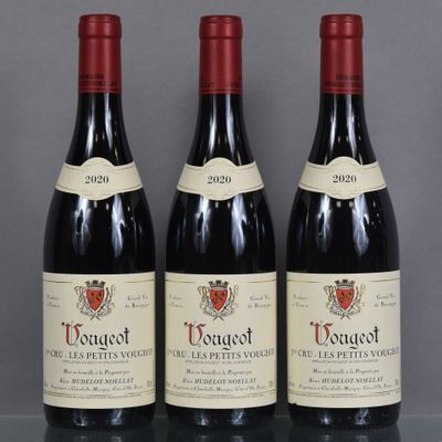three bottles of red wine sitting on top of a glass table