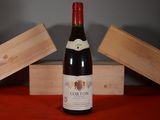 a bottle of wine sitting on a table next to two wooden boxes