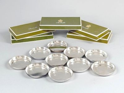a pile of silver plates sitting on top of each other