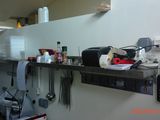 a picture of a kitchen with a lot of utensils on the counter