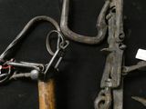 two old tools that are on a black surface