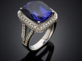 a blue sapphire and diamond ring on a black surface