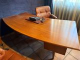 a desk with a laptop on it and a chair in front of it