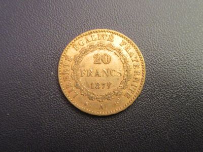 a close up of a gold coin on a black surface