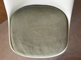an image of a white chair with a green seat pad
