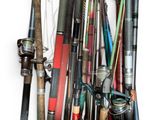 a lot of fishing rods that are hanging on the wall