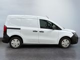 the white van is parked on the concrete floor in the room