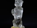a glass figurine of a bear holding a banana