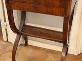 a small wooden table with a drawer on top of it