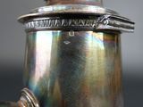 a close up of a silver coffee pot with a handle