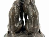 statue of two dogs sitting on a marble base