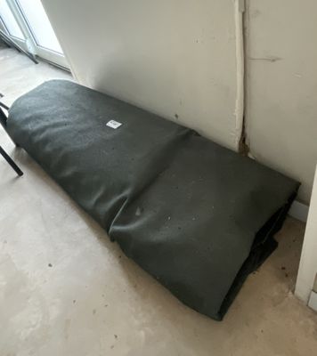 a mattress that is laying on the floor in the corner of a room